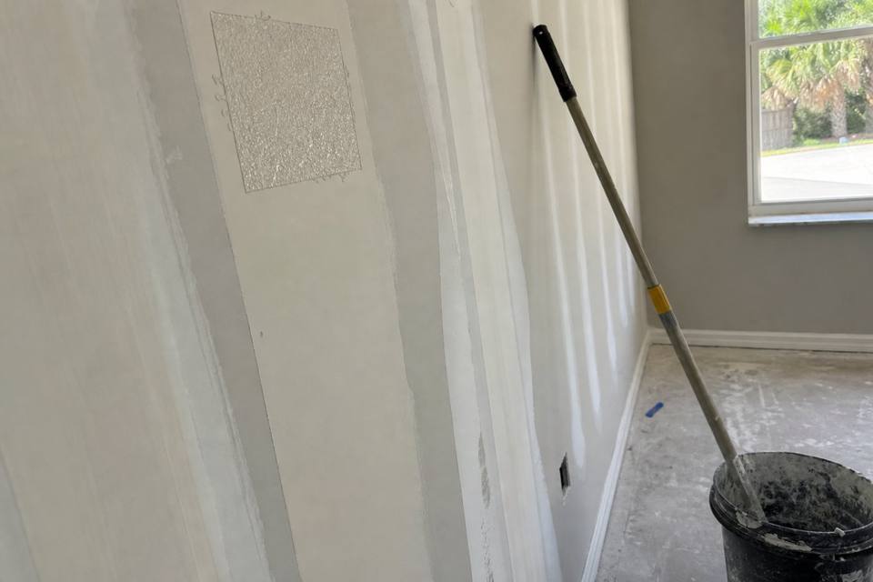 Taped seams and joint compound during drywall finishing for Daytona Beach drywall projects